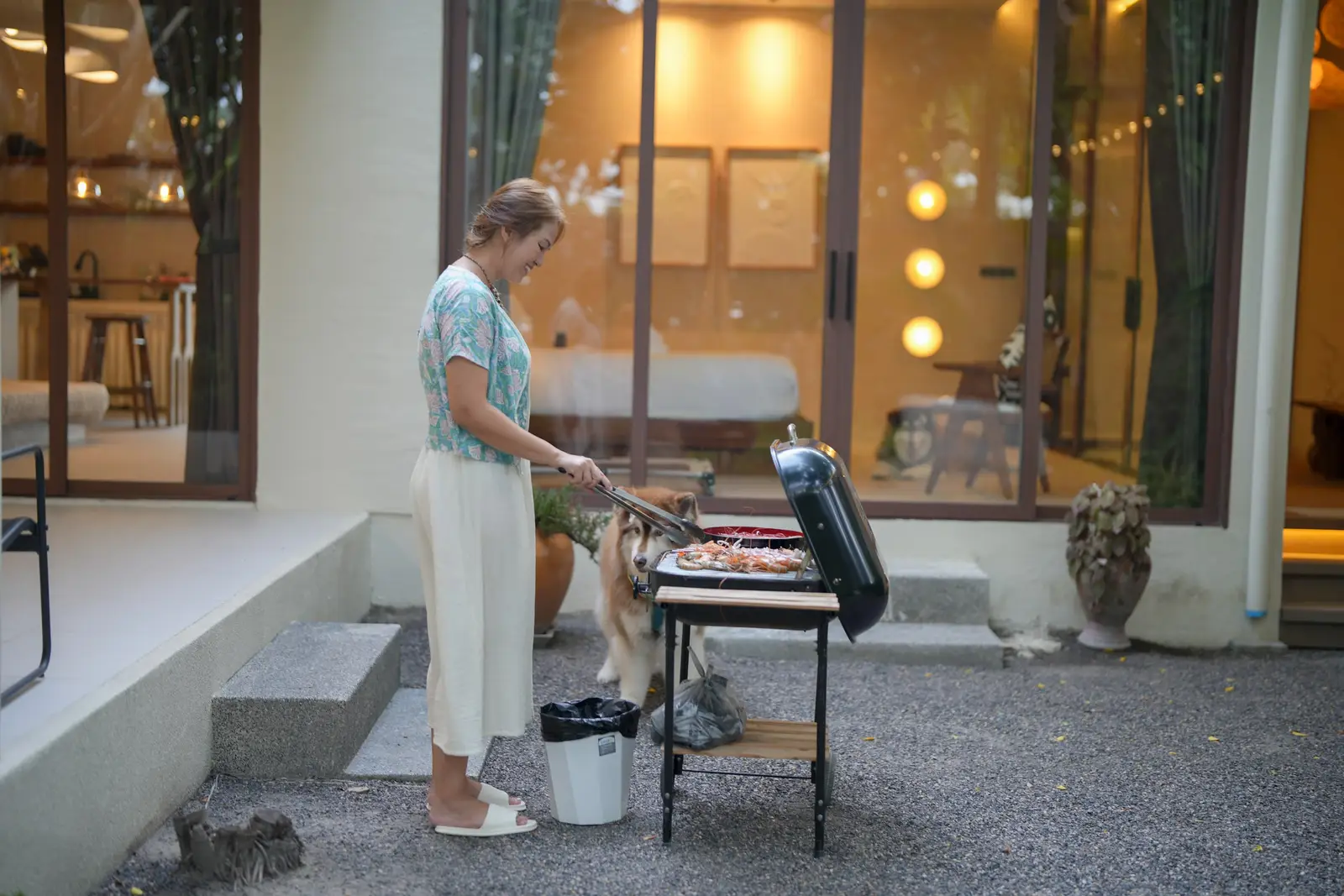 A guest grilling on the barbecue outside the villa